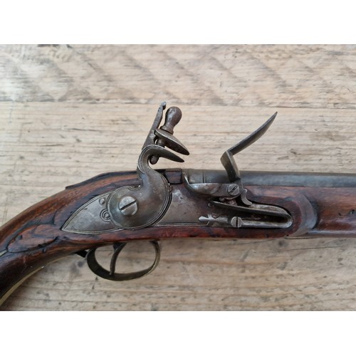 116 - A pair of reproduction flintlock pistols, 31cm barrel with ramrod below, touch hole is just an inden... 