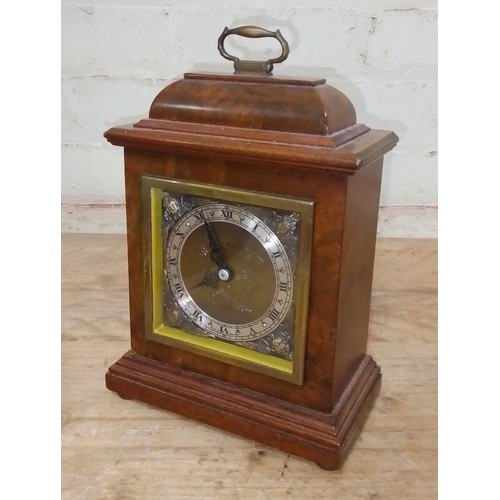 279 - An Elliott burr walnut clock, retailer's Garrard.