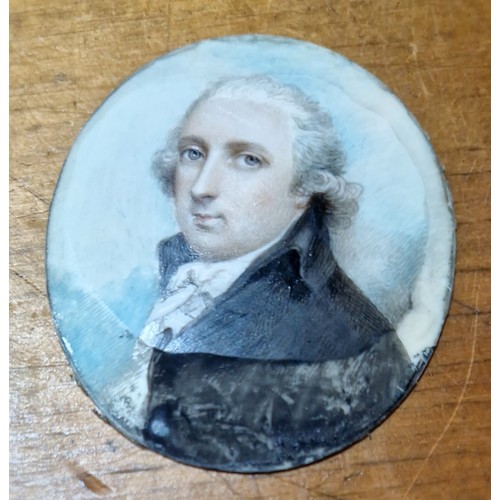 97 - An early 19th century miniature portrait on ivory, yellow metal oval frame, 5.5cm x 6.5cm, together ... 