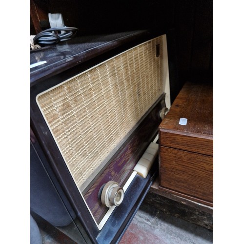 62 - An oak canteen of silver plated cutlery and a vintage radio.