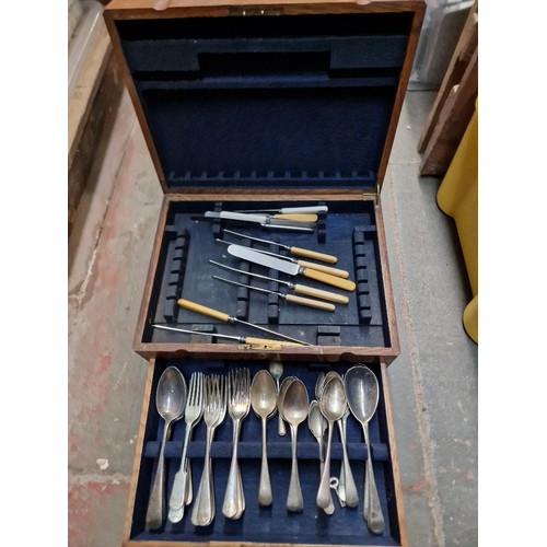 62 - An oak canteen of silver plated cutlery and a vintage radio.