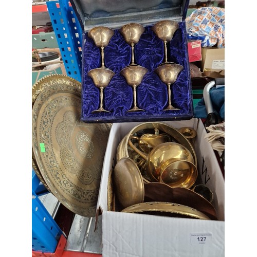 127 - A box of metal-ware, brass, two brass chargers, a set of 6 metal goblets in case, etc.