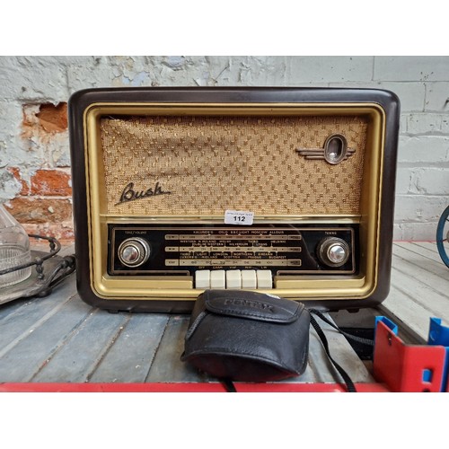 112 - A Bush vintage radio and a pair of Pentax binoculars.