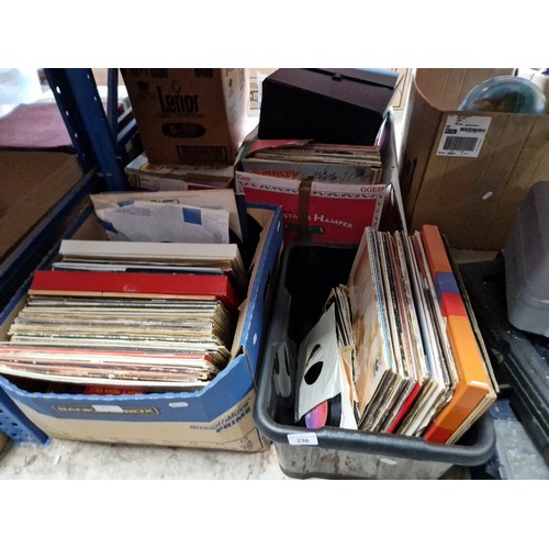 230 - Two boxes of assorted vinyl records and cassettes.