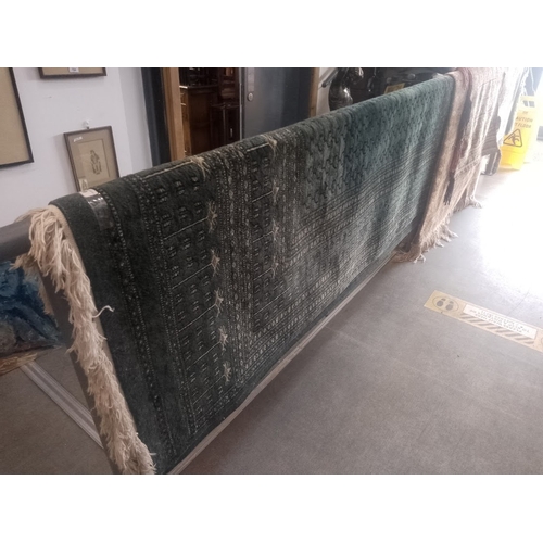 819 - A large Middle Eastern Bokhara style wool carpet, green ground, 375cm x 284cm (approx)