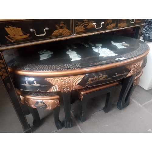 851 - A Chinese black lacquer and gilt decorated coffee table / nest of tables decorated with mother of pe... 