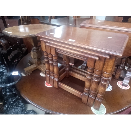 855 - A Bevan Funnell aged oak nest of tables together with an oak occasional table.