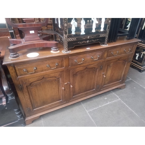 860 - A Georgian style aged oak sideboard.