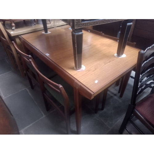 868 - A mid 20th century teak extending dining table and four chairs.