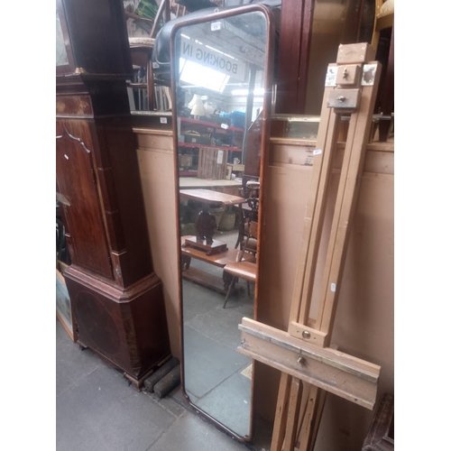 878 - A 1930s walnut framed full length mirror.