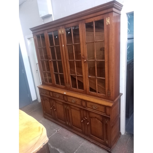 898 - A Titchmarsh & Goodwin aged oak cabinet bookcase.