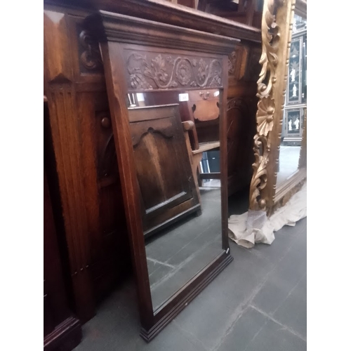 905 - A carved oak frame wall mirror.