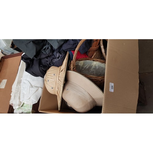 350 - A signed dog figure, wicker baskets, outdoor waxed clothing, a box and a case of linen / material, e... 