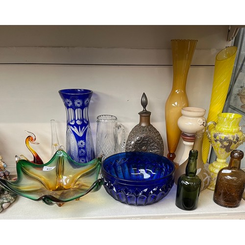 658 - A collection of glassware to include coloured glass, copper cased three sided bottle, various other ... 