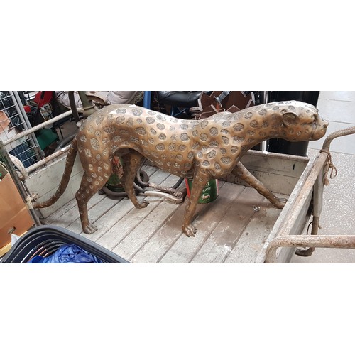 390 - A large modern bronze/brass model depicting a prowling Cheetah, length 145cm Height 53cm Width 21cm