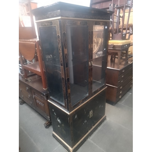 912 - A Chinese black lacquer and gilt decorated display cabinet.