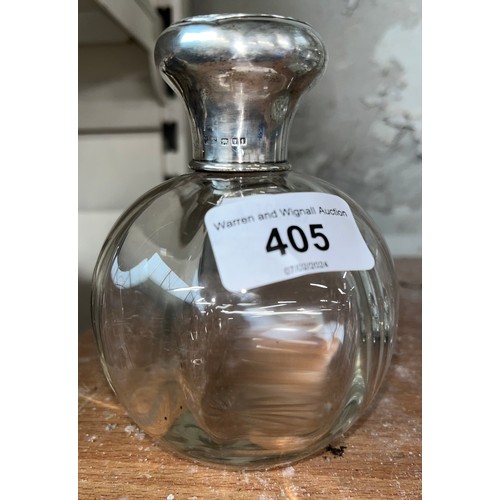 405 - A cut glass perfume / scent bottle with stopper, silver collar and top, Mappin & Webb London 1925.