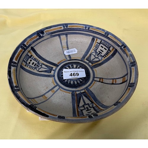 469 - An early Poole Pottery shallow dish painted in pale blue and amber with segmented panels and stylise... 