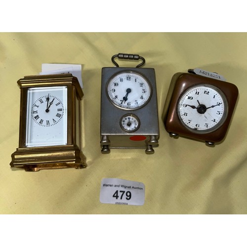 479 - A miniature brass carriage clock and two other miniature clocks.