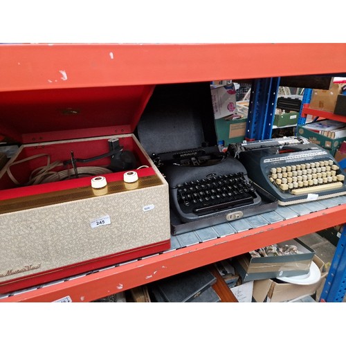 245 - HMV record player together with 2 typewriters.