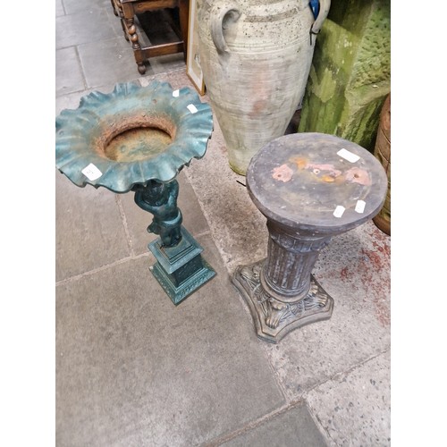 287 - A terracotta column plinth and a Victorian cast iron birdbath.