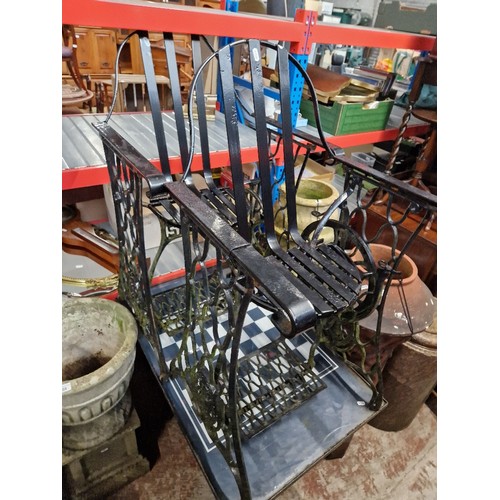 285 - A Singer treddle chess table and 2 wrought metal chairs. with Singer bases.