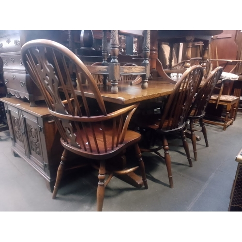 919 - An aged oak refectory table and six chairs (two Windsor) with crinoline stretchers.