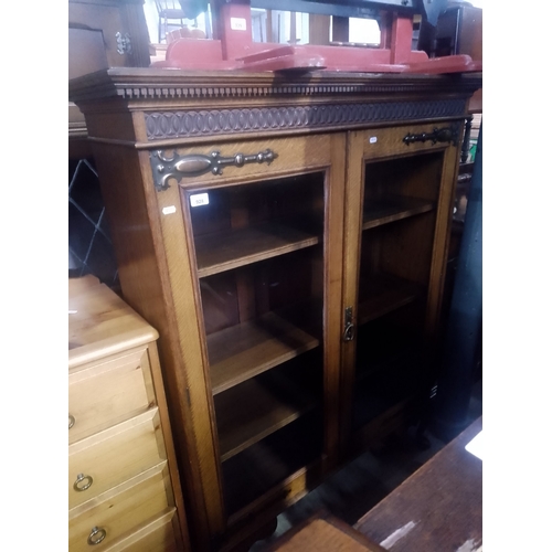 928 - An early 20th century glazed oak bookcase.