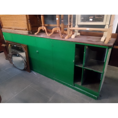 937 - A large green painted mahogany sideboard.