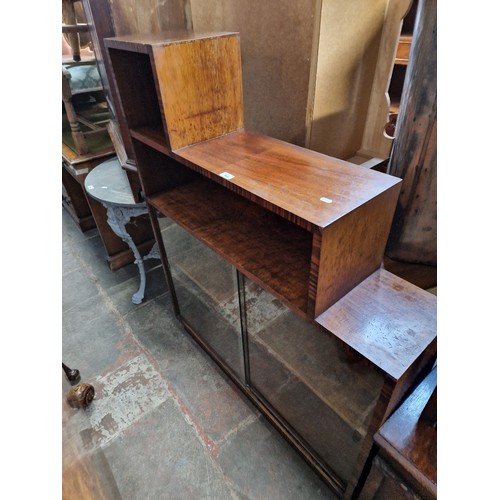 964 - A vintage mahogany bookcase with sliding glass doors.