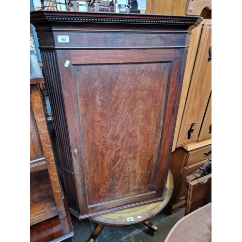 968 - A Georgian mahogany corner cabinet.