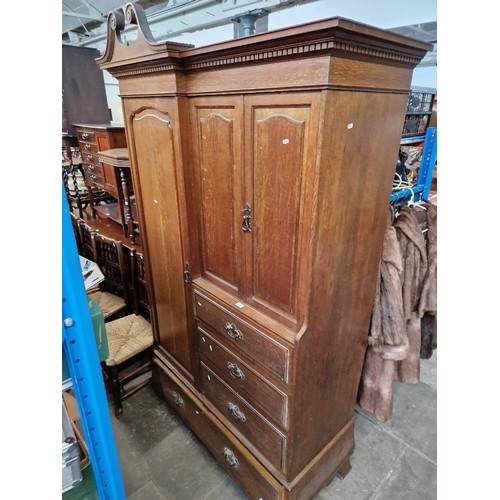 977 - An Edwardian oak wardrobe, the locks stamped 'GILLOWS LANCASTER'.