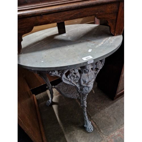 963 - A cast metal and composite top table.