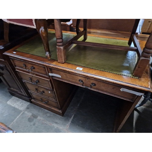 961 - A single pedestal four drawer mahogany desk with leather top.