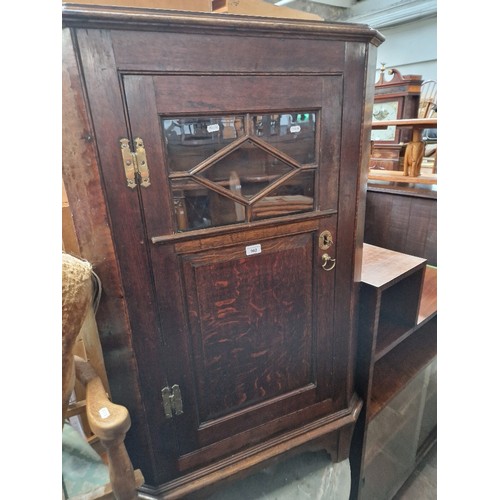 962 - A Georgian oak corner cabinet.