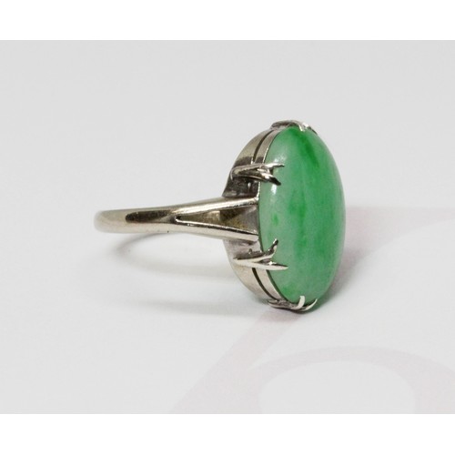 14 - A jadeite jade cabochon ring, the six claw set stone measuring approximately 15mm x 10mm, depth 3.43... 