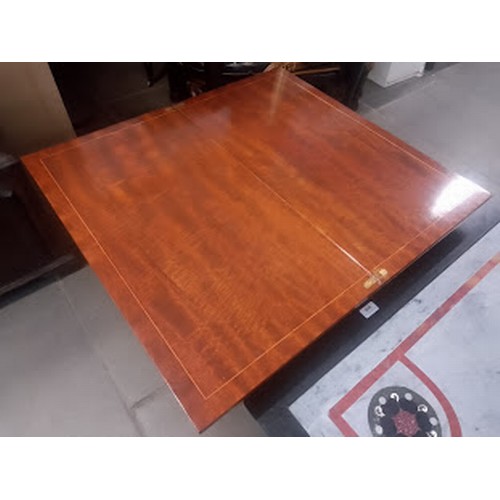 875 - A mahogany fold top card table.