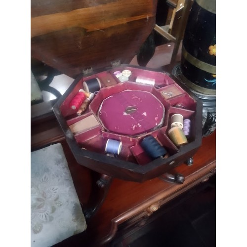 841 - A Victorian rosewood sewing table together with a footstool of a similar age.