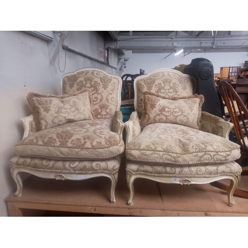 882 - A pair of French style armchairs.