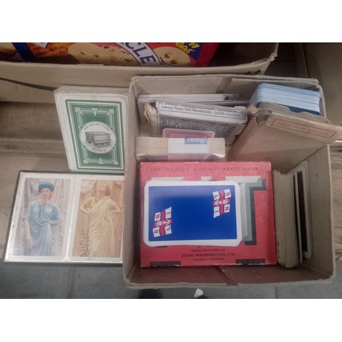 29 - Four boxes of vintage playing cards, etc.