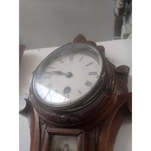 750 - A Victorian carved oak barometer with clock.