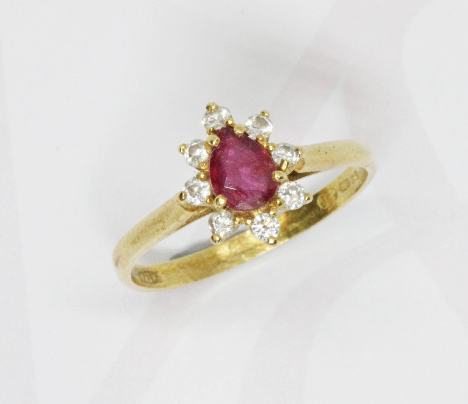 An 18ct gold diamond and ruby cluster ring, the cluster measuring ...