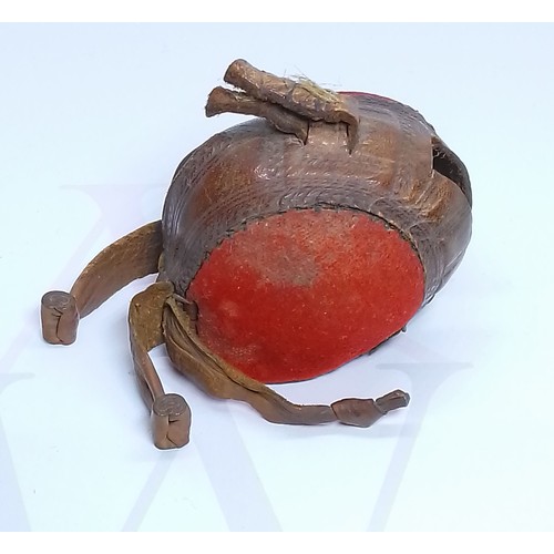 260 - A 19th century leather and red fabric falconry hood, length 6.5cm.