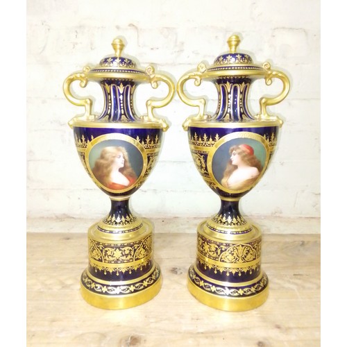 265 - A large pair of 'Vienna' porcelain urns, gilt decoration on blue ground with painted panels entitled... 