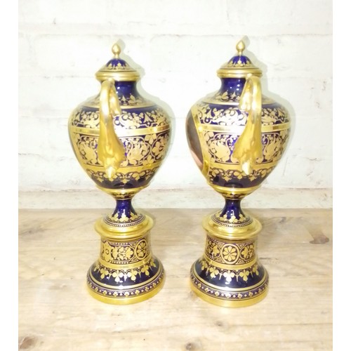 266 - A pair of 'Vienna' porcelain urns, gilt decoration on blue ground with painted portraits 'Odalysque'... 