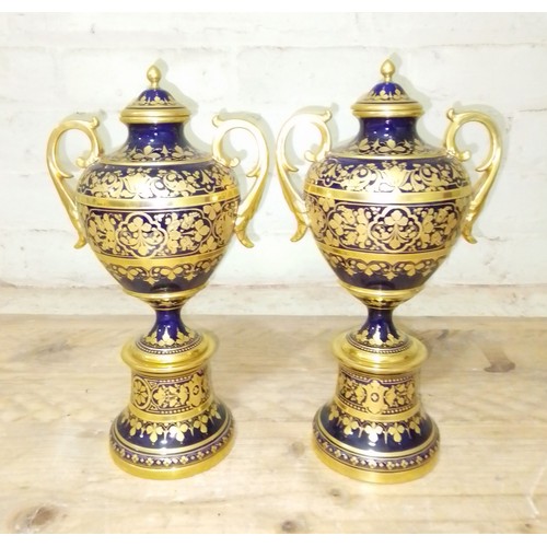 266 - A pair of 'Vienna' porcelain urns, gilt decoration on blue ground with painted portraits 'Odalysque'... 