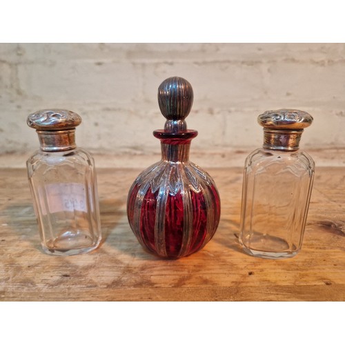 345 - A pair of cut glass perfume bottles with silver top together with a cranberry glass with silver over... 