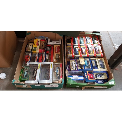 597 - 32 boxed model vehicles including Burago, Dinky, Matchbox etc.