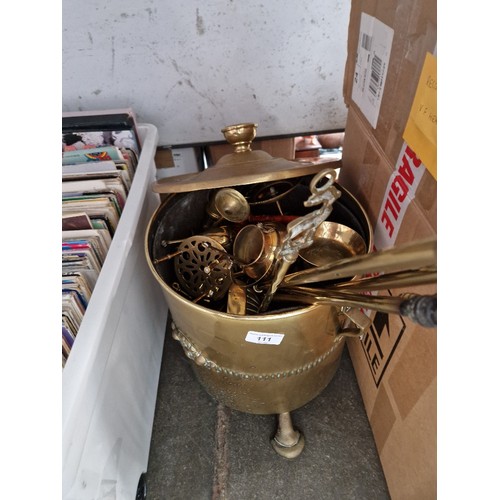 111 - A brass coal bucket, brass fire irons, miniature miner's lamp, trivets, etc.