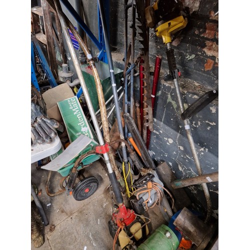 208 - A quantity of garden tools including two petrol strimmer/brush cutters, electric chainsaw, lawn feed... 